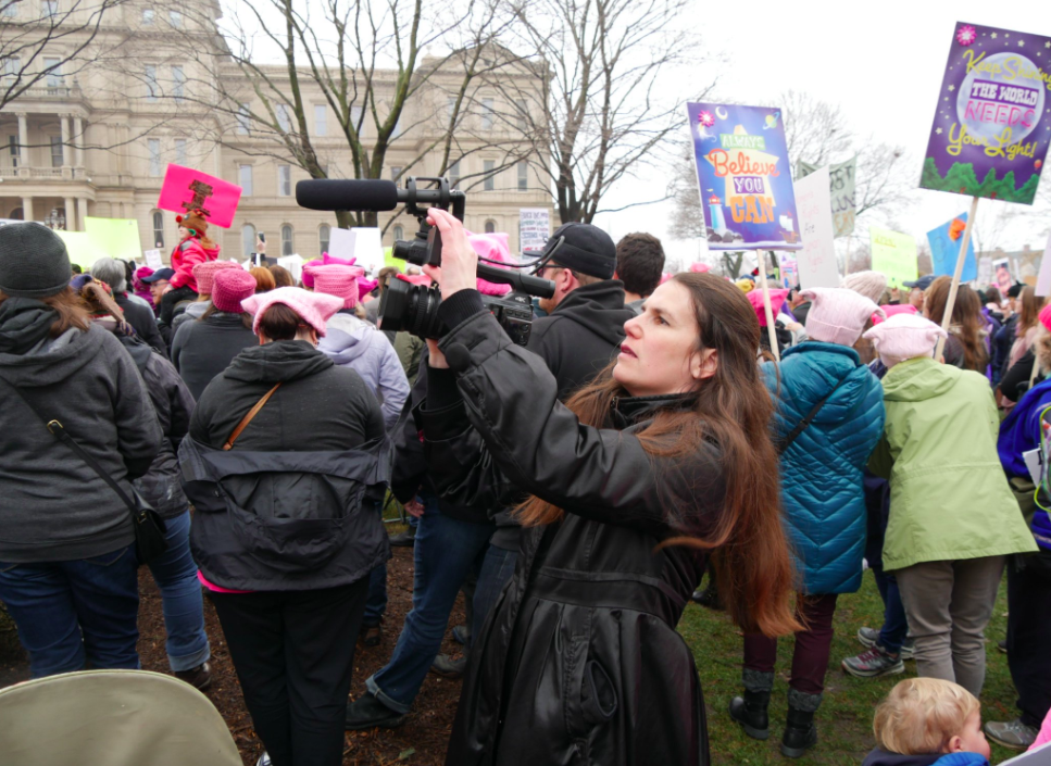 Alexandra Hidalgo filming at the Lansing Women's March. Photo by Nathaniel Bowler.